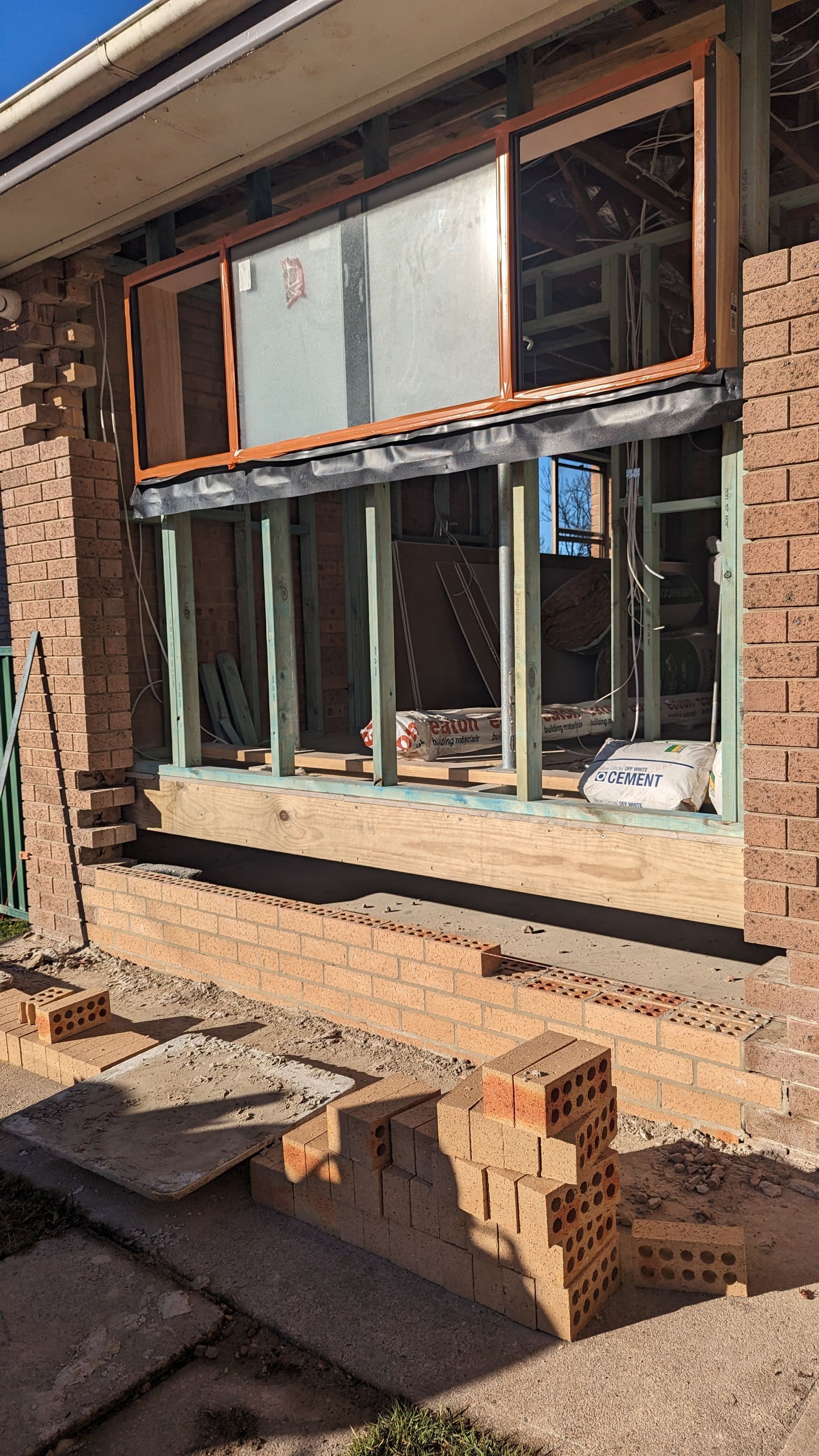 A Shelf Filled With Wooden Boards on a Wall — TM Built Construction In Lochinvar, NSW