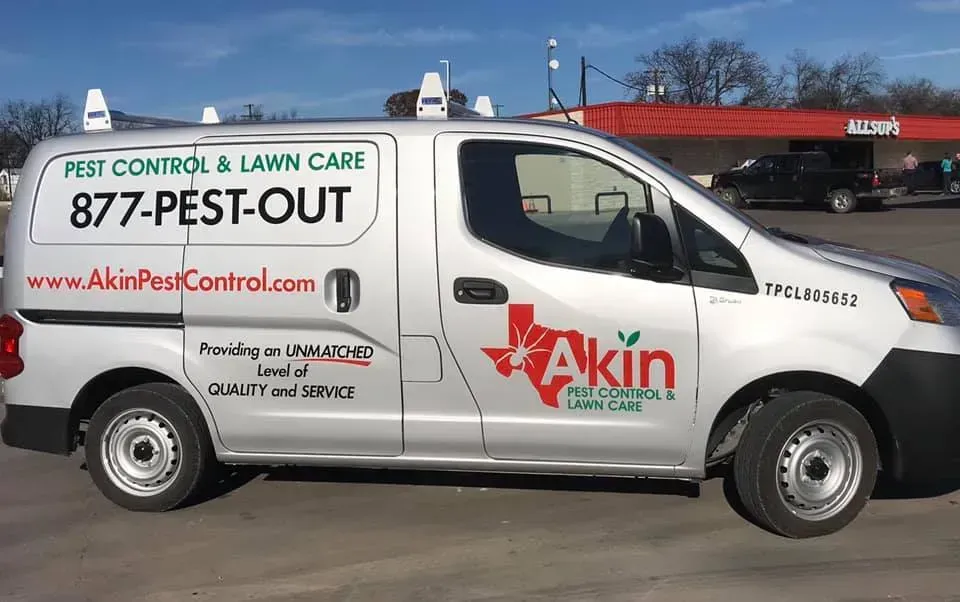 A white van is parked in a parking lot.