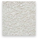 White textured plaster wall surface with a rough, uneven pattern