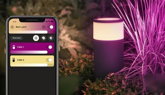 Smart outdoor light controlled via a mobile app, shown in a garden setting at night.