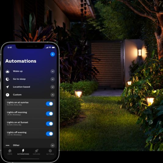 Mobile app interface for automating smart light bulbs, showing outdoor and indoor light control options