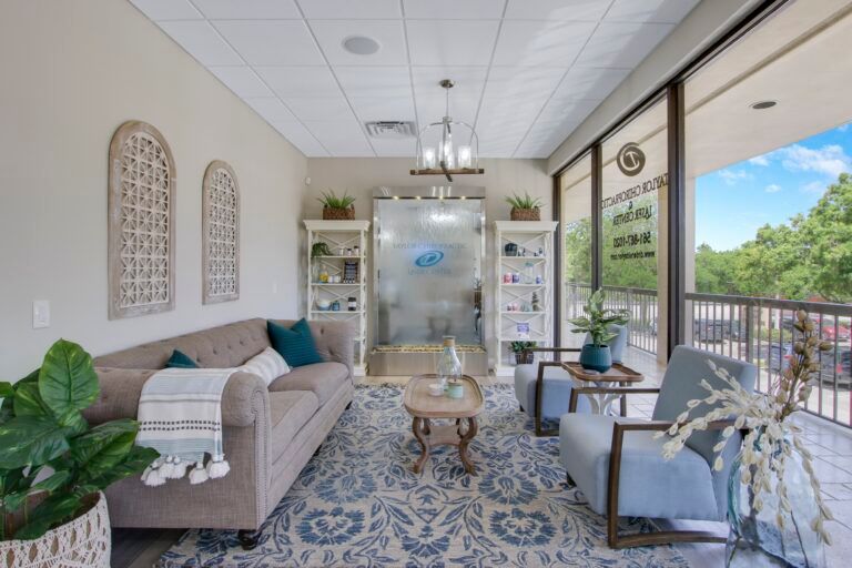 A living room with a couch , chairs , and a table.