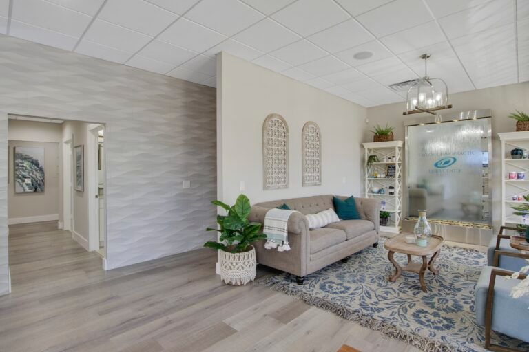A living room with a couch , chairs , and a table.