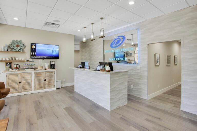 A dental office with a reception desk and a television on the wall.