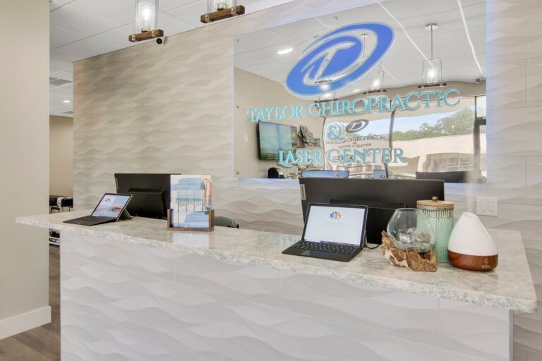 A reception desk in a chiropractic office with laptops on it.