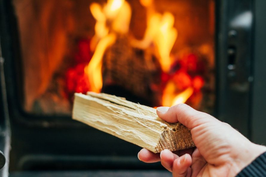 placing wood in the fire