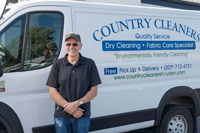 Country Cleaners delivery driver beside the pickup and delivery van
