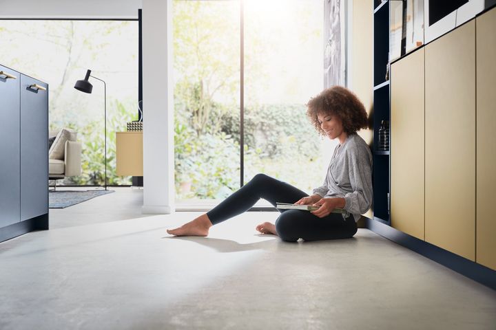 Beckermann Colorado kitchen - lady sitting on floor