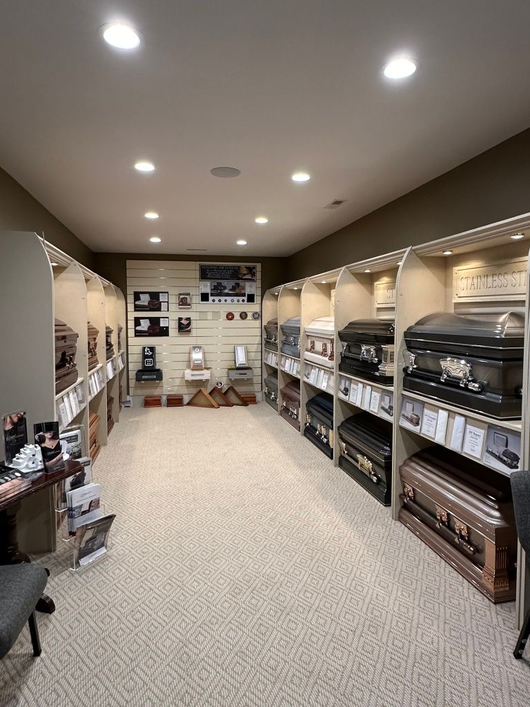Neatly organized walk-in closet with shelves of folded clothes, hanging garments, and recessed ceiling lights.