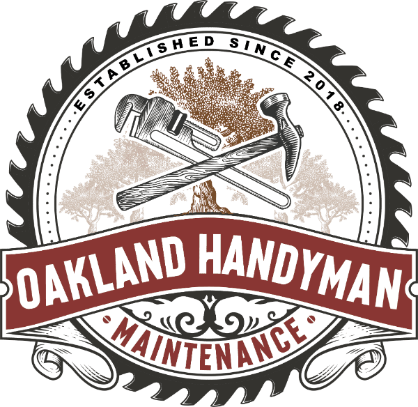Smiling bald man in black jacket with red gloves, arms crossed, standing before a black Oakland Hauling truck