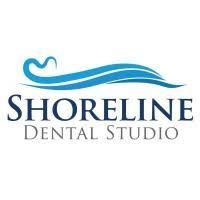 Logo for Shoreline Dental Studio: blue wave over dark blue text,