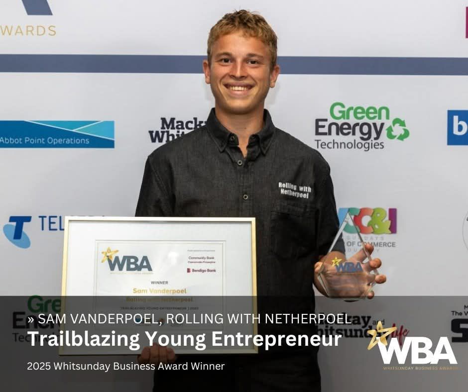 Young entrepreneur holding a framed award and trophy at a business awards event backdrop — Rolling With Netherpoel in Bowen, QLD
