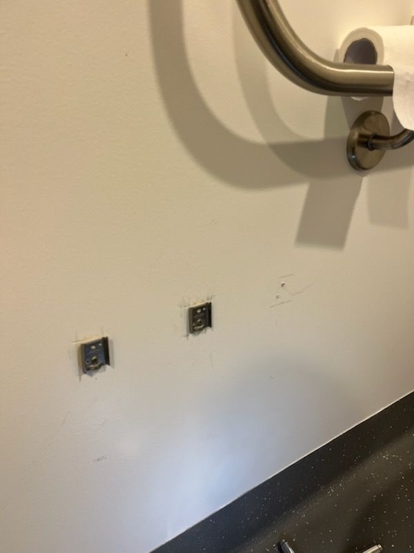 Wall with handle bars above a black countertop or ledge, near a stainless grab bar — Rolling With Netherpoel in Bowen, QLD
