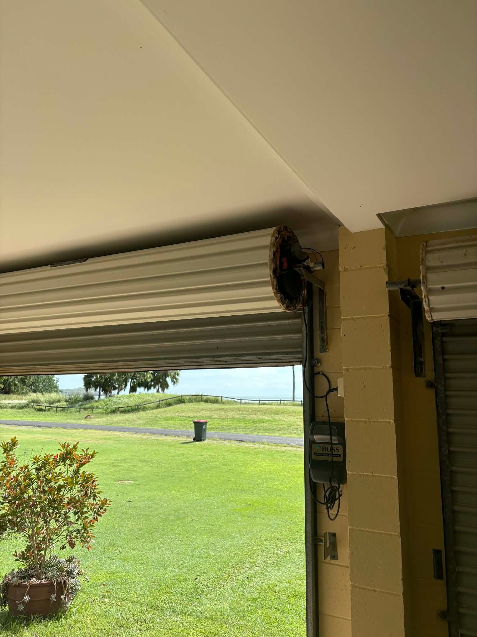 Bottom of Wooden Door With Brass Kick Plate Beside a Glass Door on a Concrete Floor — Rolling With Netherpoel in Bowen, QLD