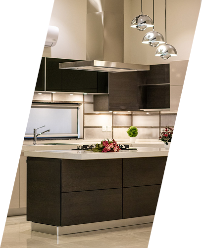Modern kitchen with dark cabinets, light island, stainless hood, and hanging pendant lights