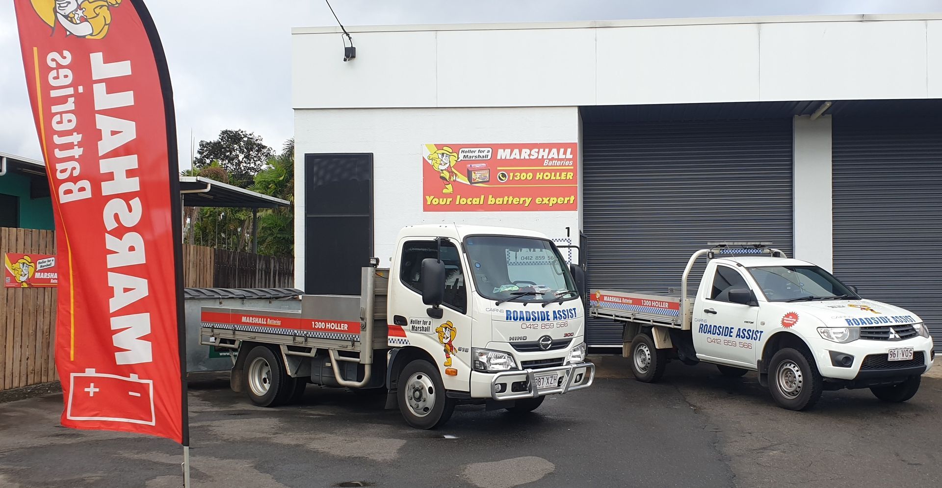 A Man Is Working On The Engine Of A Car With A Screwdriver — Cairns Roadside Assist In Manunda, QLD