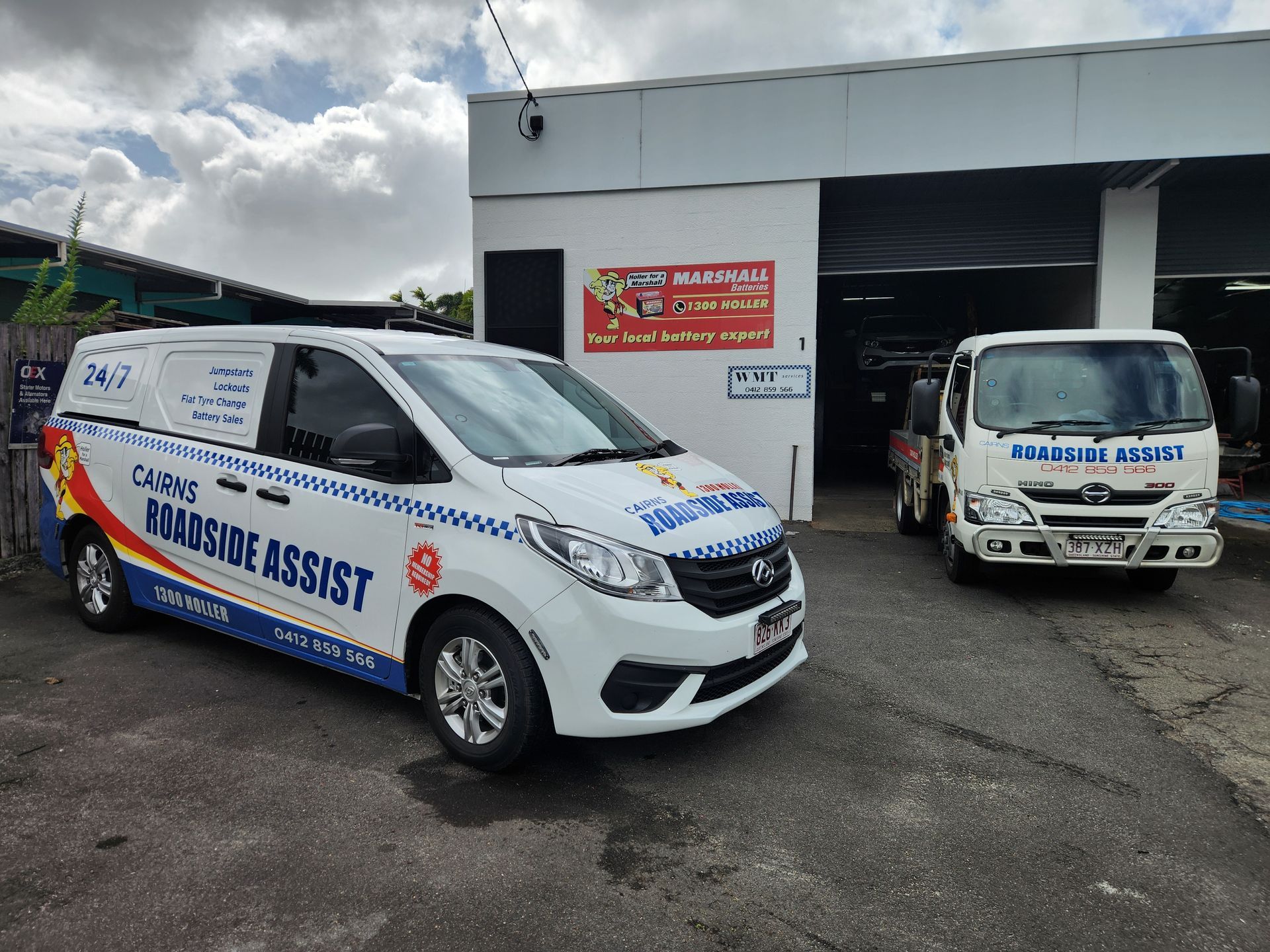 Two White Vans Parked On A Driveway In Front Of A Garage — Cairns Roadside Assist In Cairns, QLD