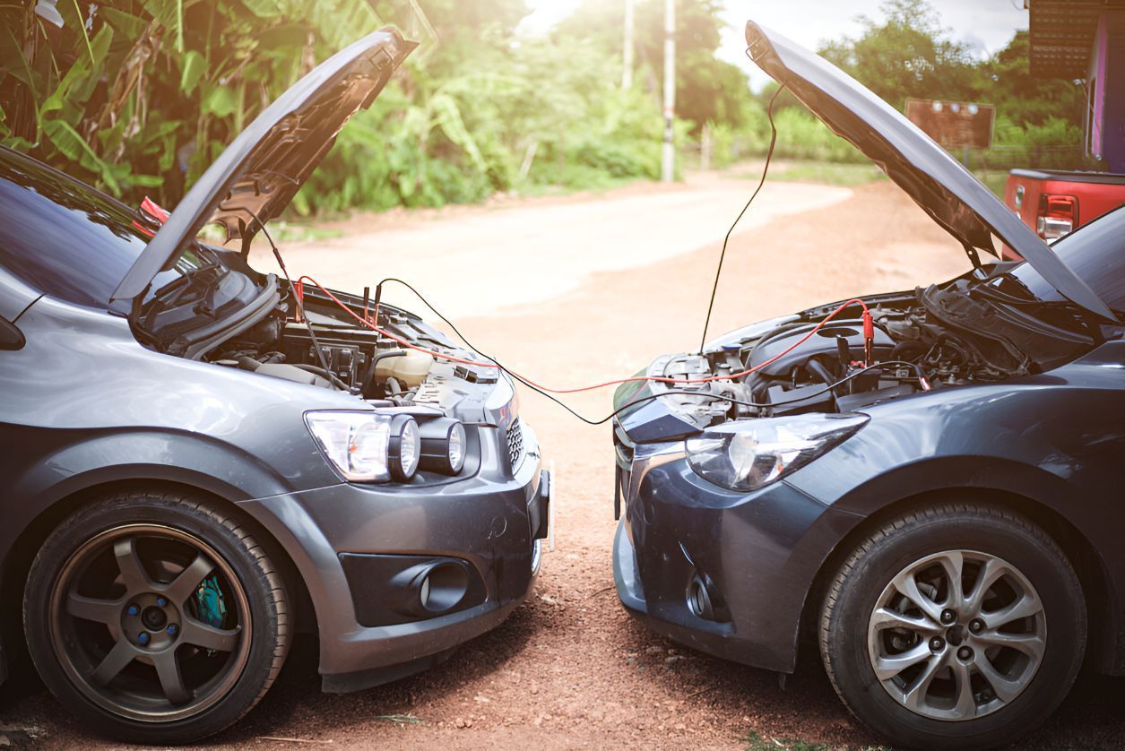 Two Cars Are Connected To Each Other With Their Hoods Open — Cairns Roadside Assist In Cairns, QLD