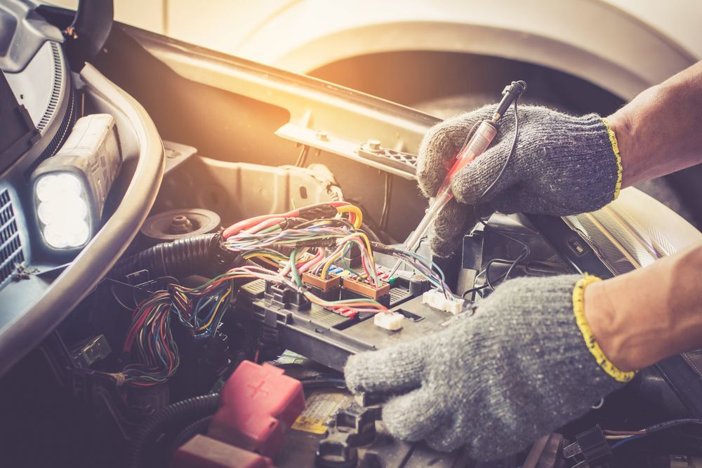 A Person Is Working On The Engine Of A Car — Cairns Roadside Assist In Gordonvale, QLD