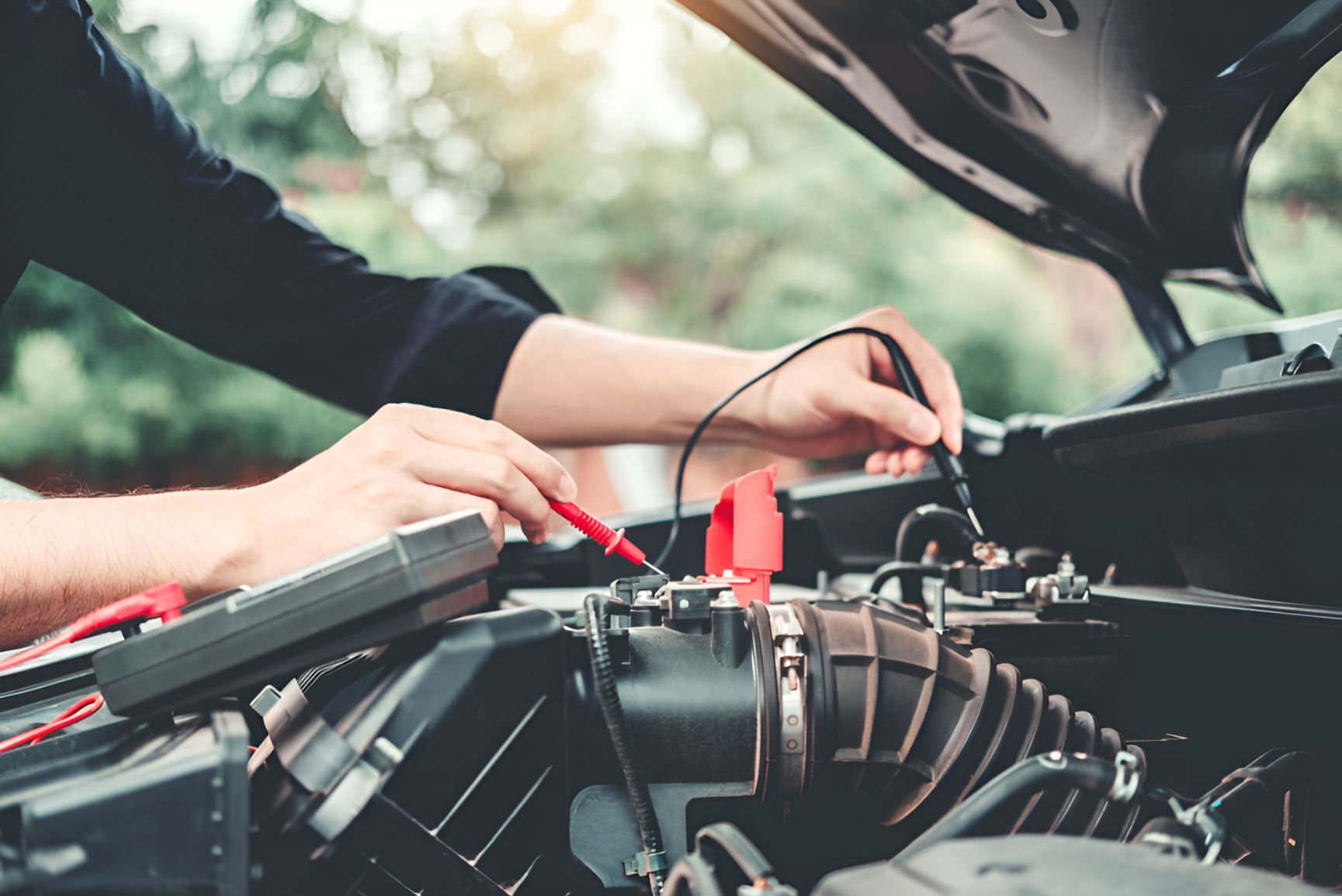 A Man Is Working On The Engine Of A Car — Cairns Roadside Assist In Kuranda, QLD