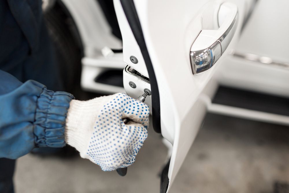 A Person Is Opening A Car Door With A Key — Cairns Roadside Assist In Gordonvale, QLD