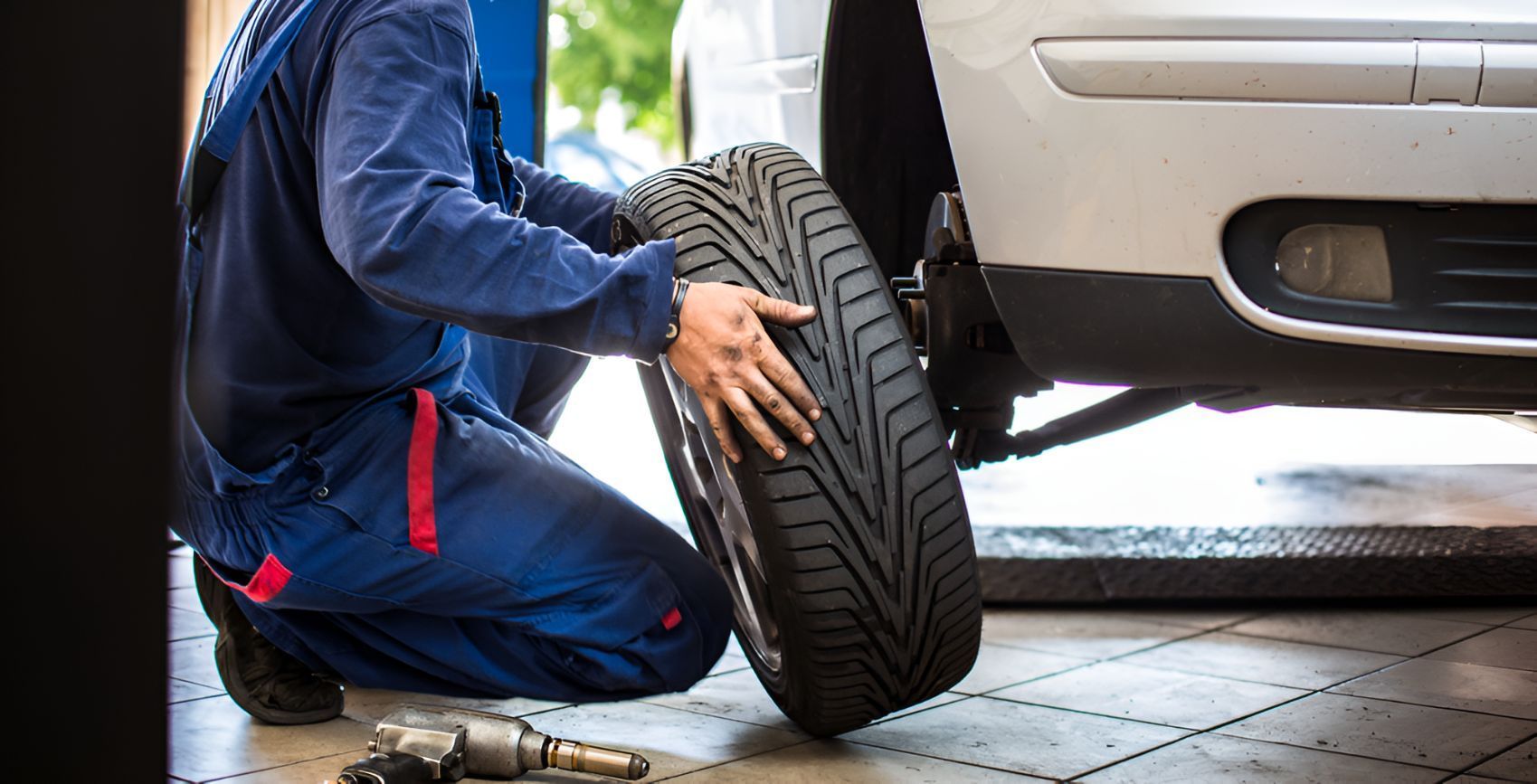 A Man is Changing A Car Tyre— Cairns Roadside Assist In Gordonvale, QLD