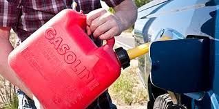 A Red Petrol Can Being Used toPour Petrol Into A Car — Cairns Roadside Assist In Port Douglas, QLD