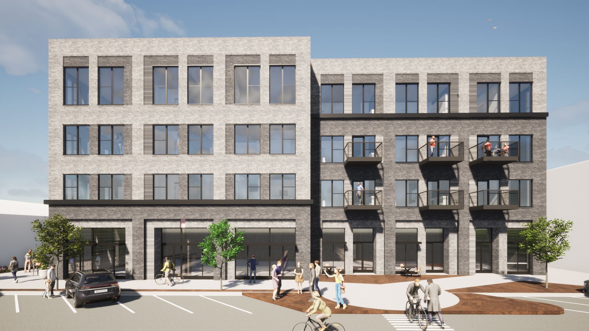 Multi-story brick building with street-level retail, pedestrians, and cars.