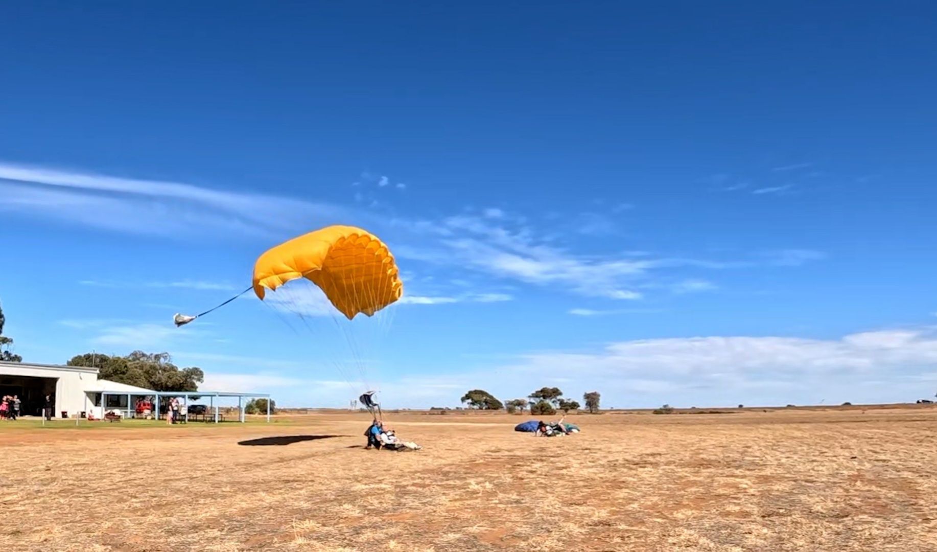 Tandem skydivers landing