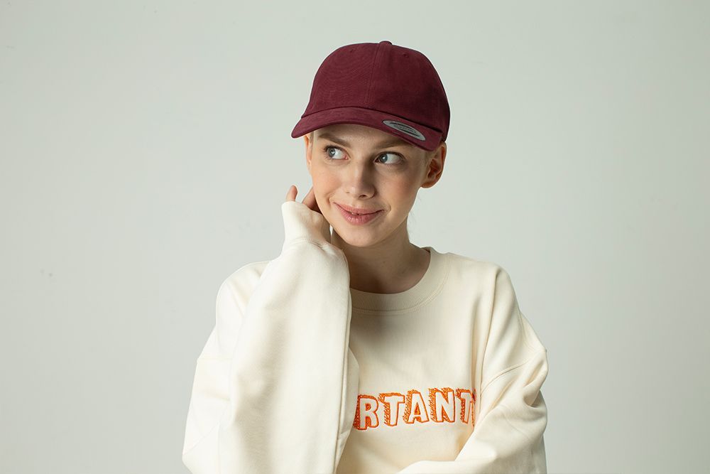 Woman Wearing a Maroon Cap, Showcasing Stylish Headwear Options — Screen Printer in Dubbo, NSW