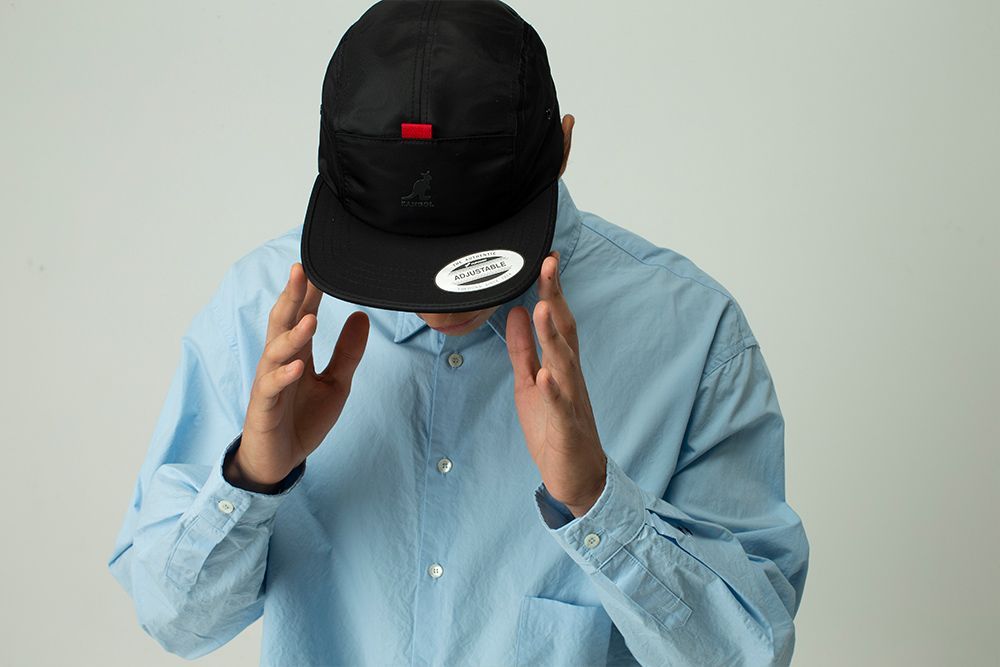 Man Holding a Black Cap, Showcasing The Quality And Style of Our Products — Screen Printer in Dubbo, NSW