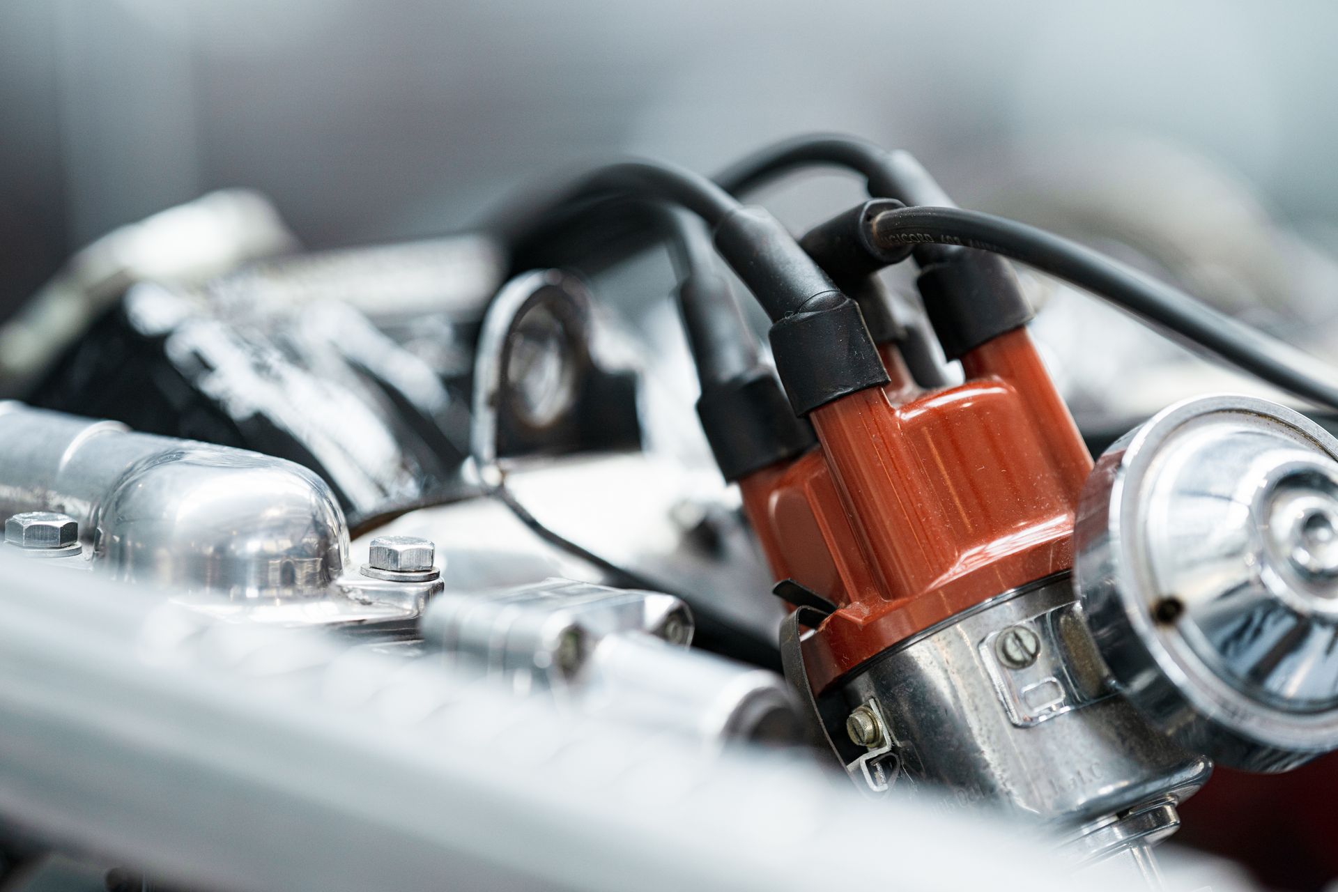 Close-up of a car engine with red ignition coils and black spark plug wires