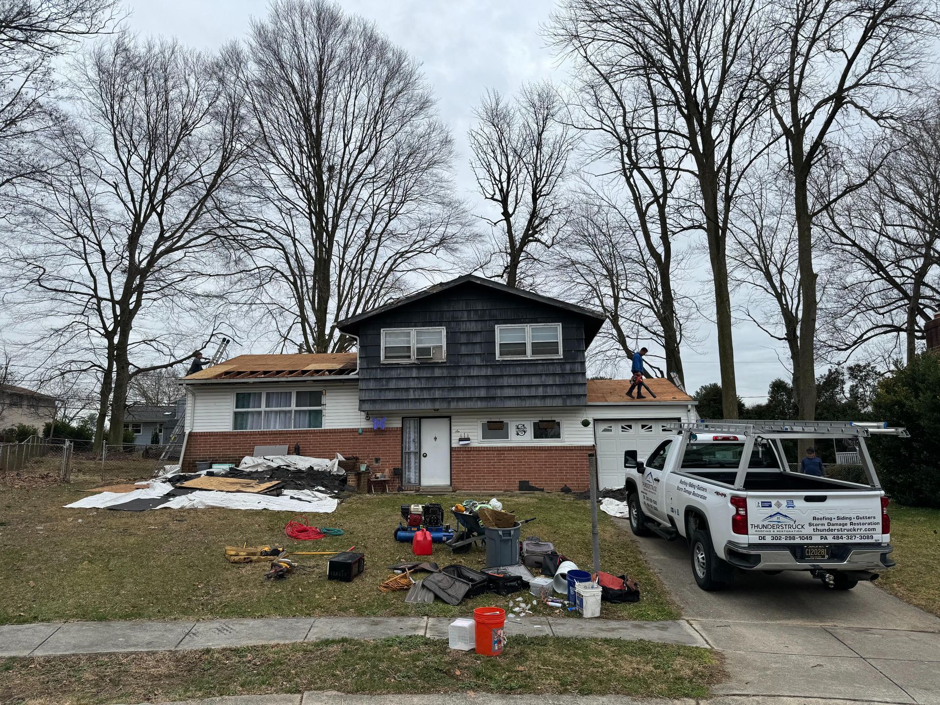 A truck is parked in front of a house that is being remodeled.