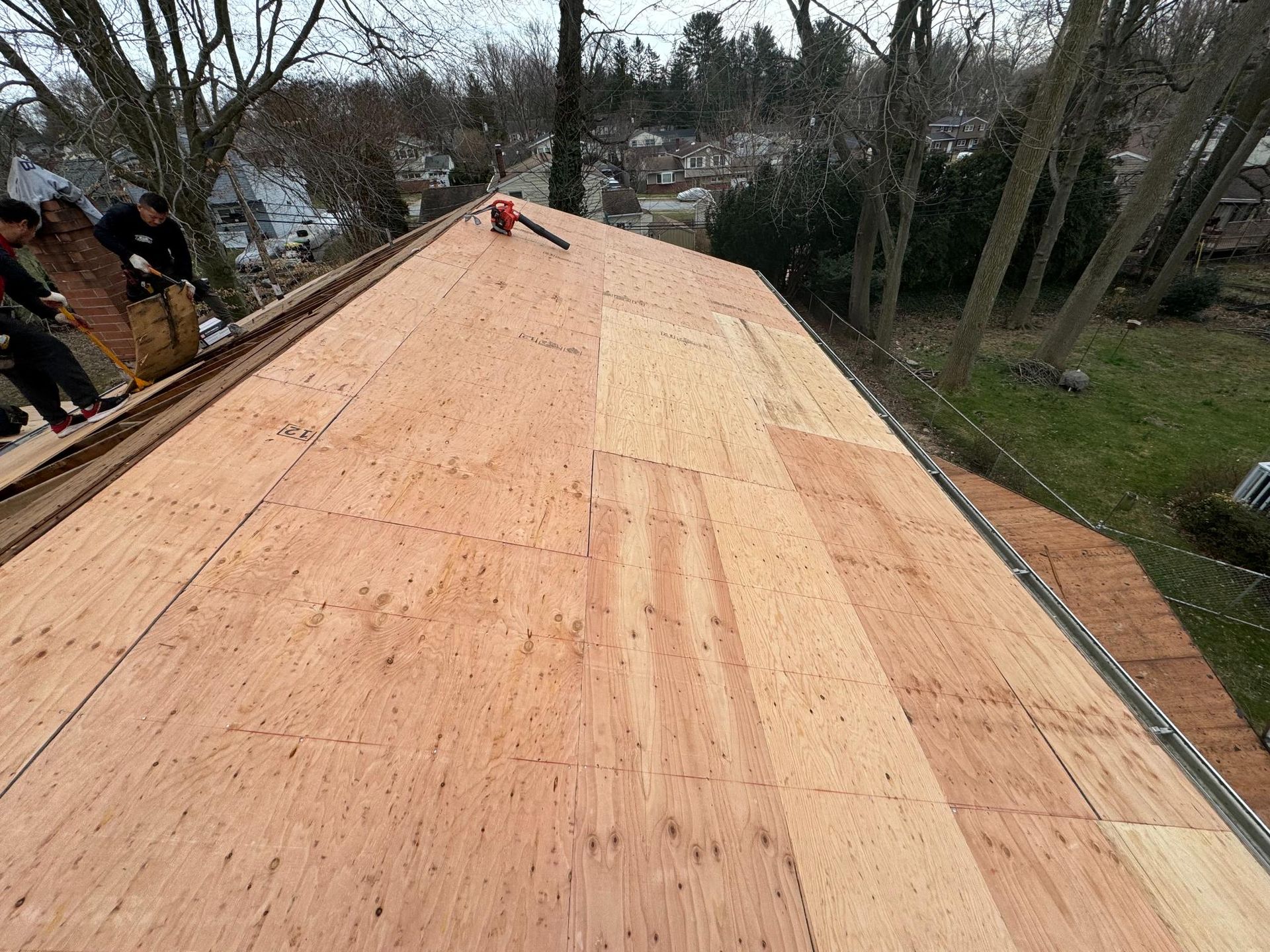 A roof with a lot of plywood on it is being built.