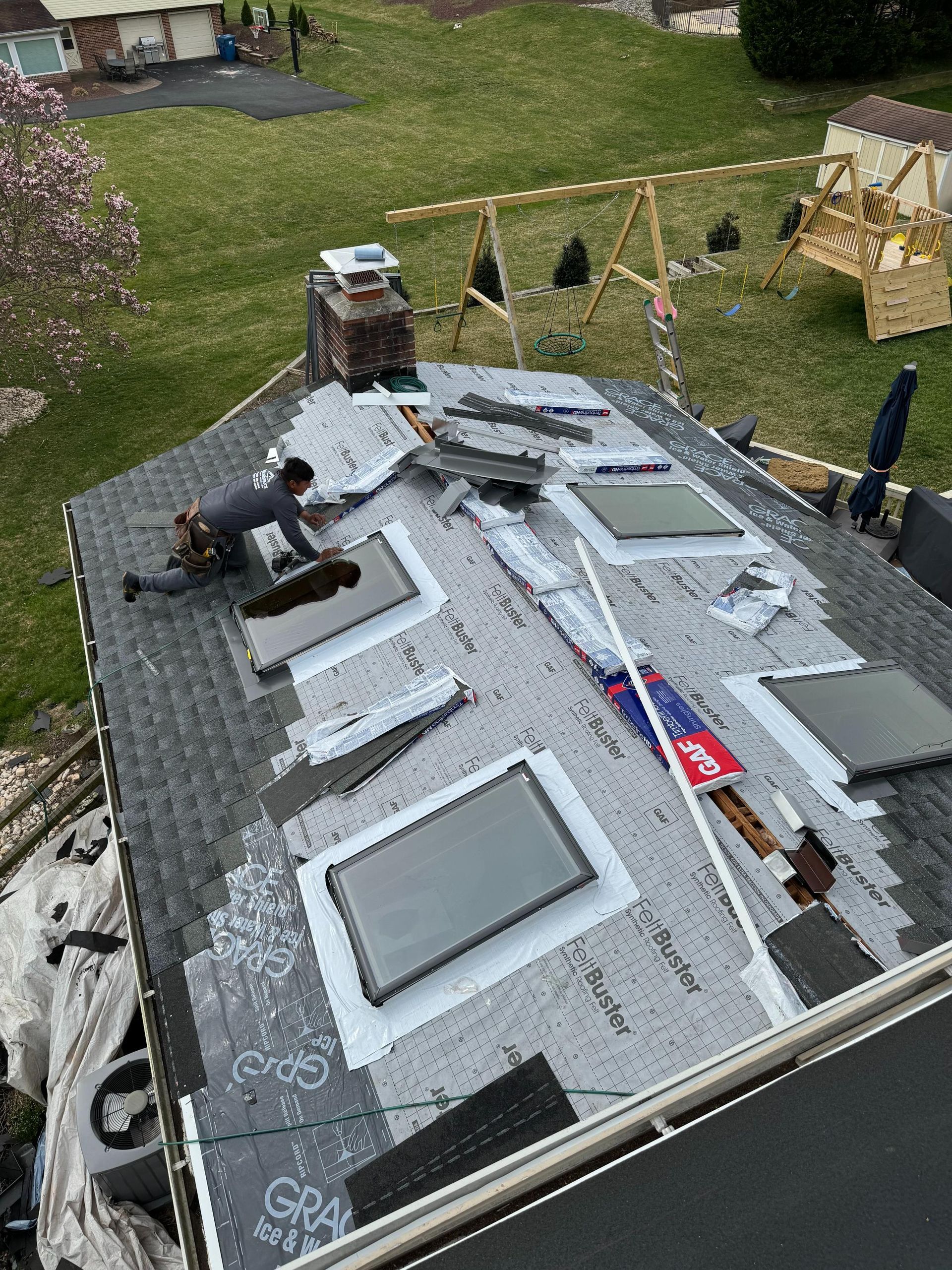 A man is working on the roof of a house.