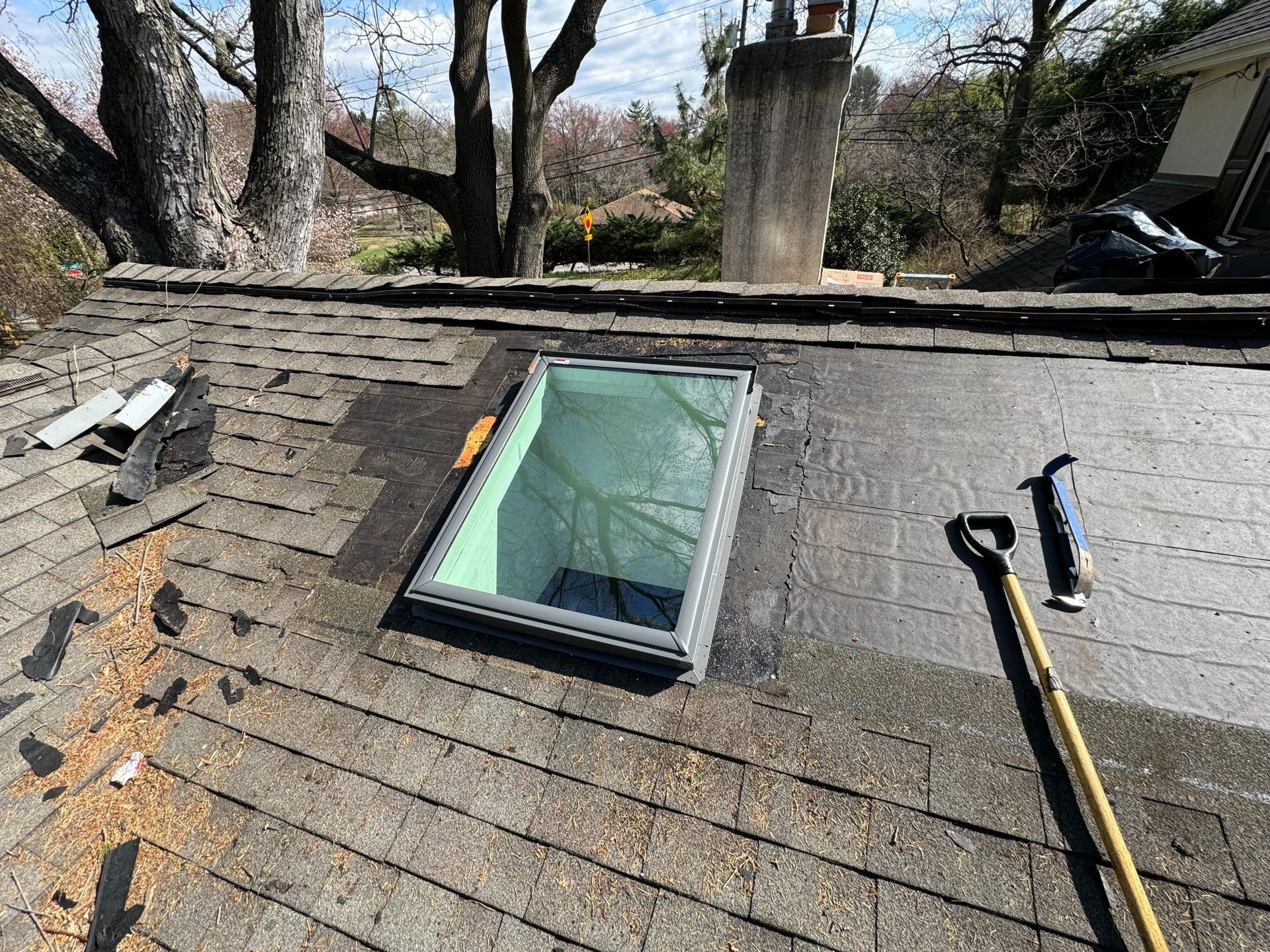 A skylight is being installed on the roof of a house.