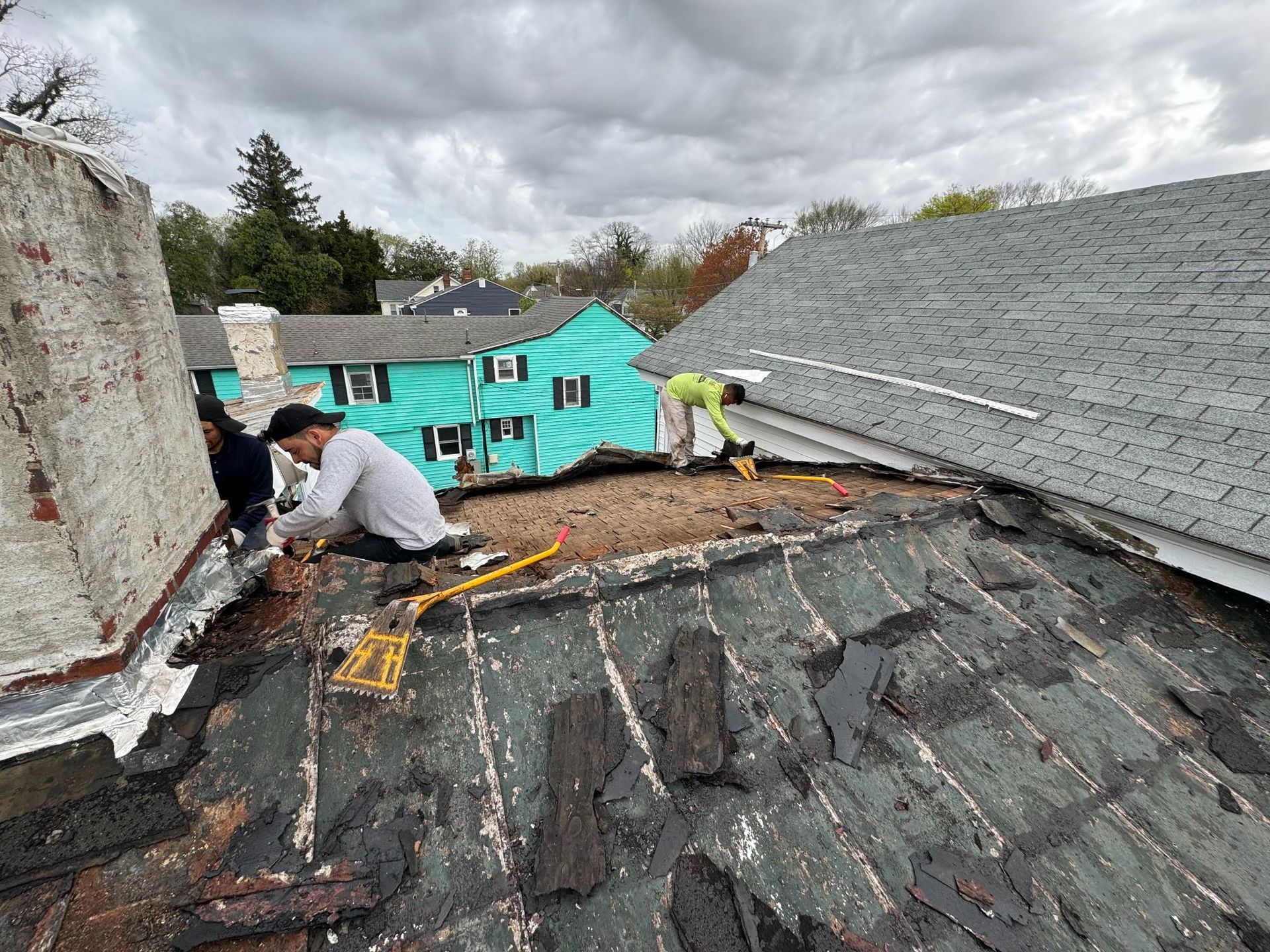 A man is working on the roof of a house.