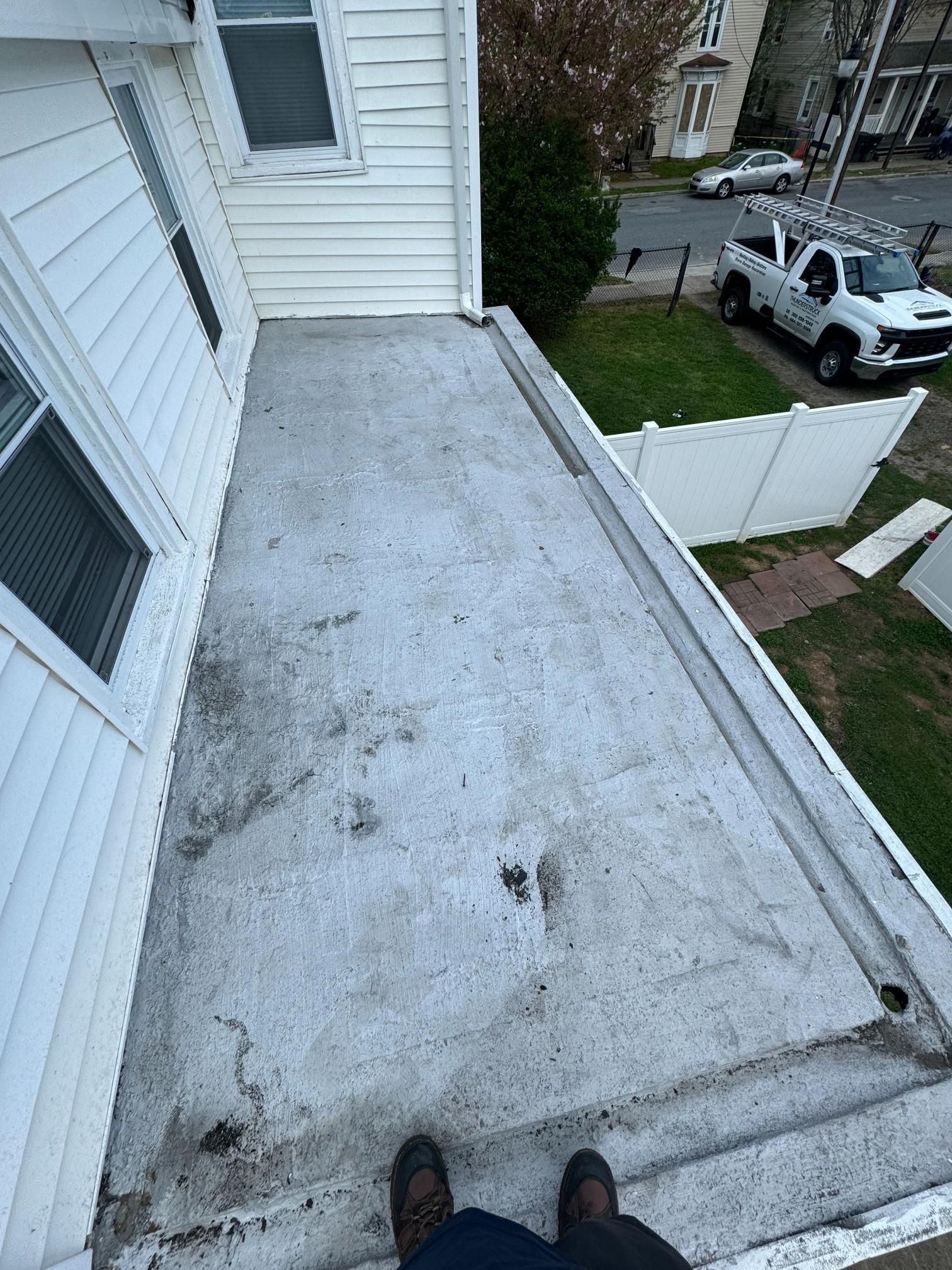 A person is standing on the roof of a house.