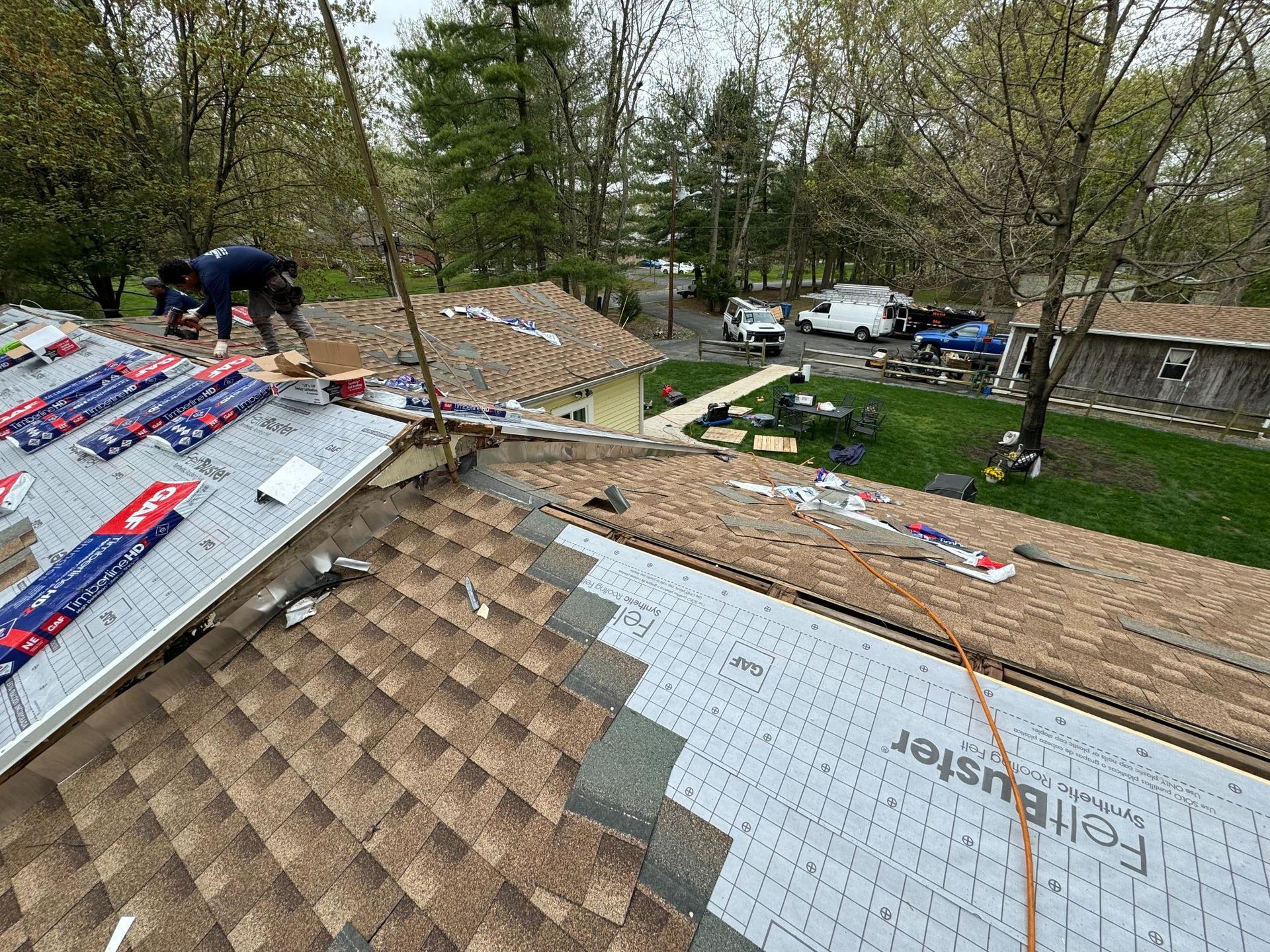 A group of men are working on the roof of a house.