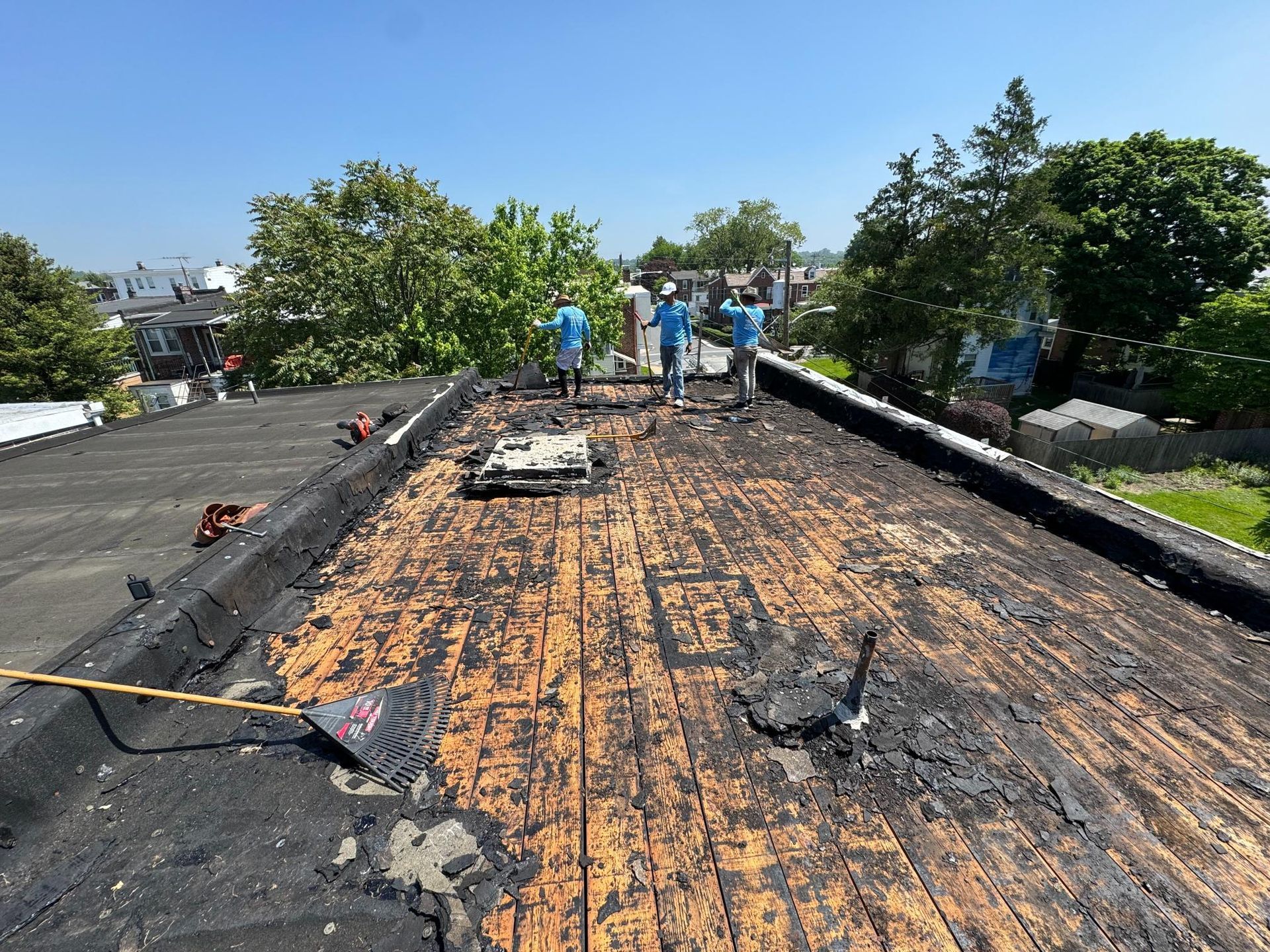 A group of people are standing on top of a roof.