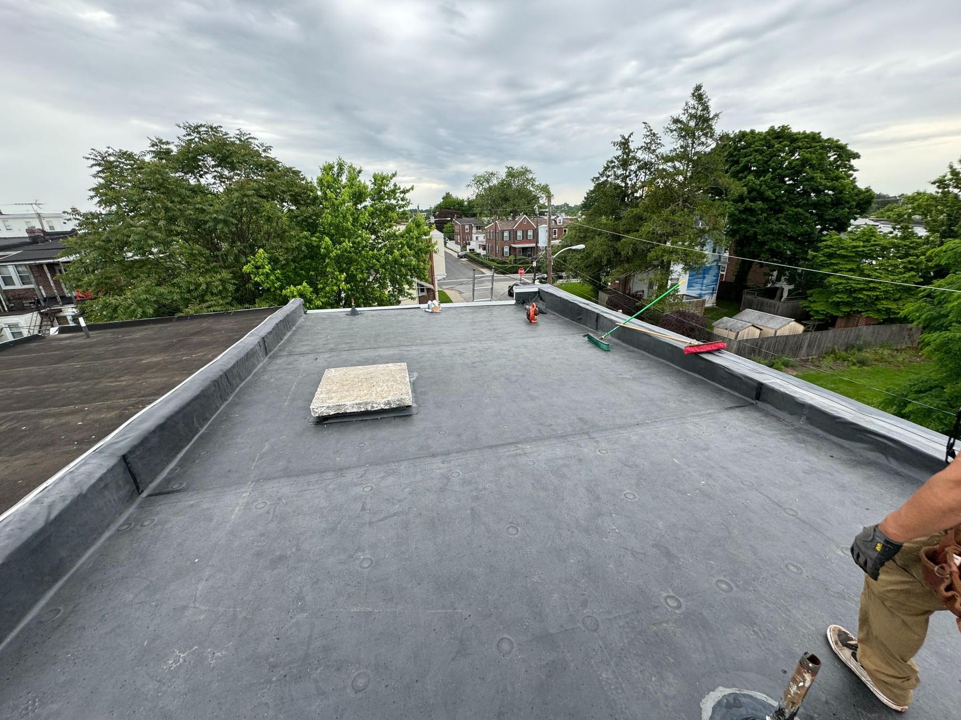 A person is standing on top of a flat roof.