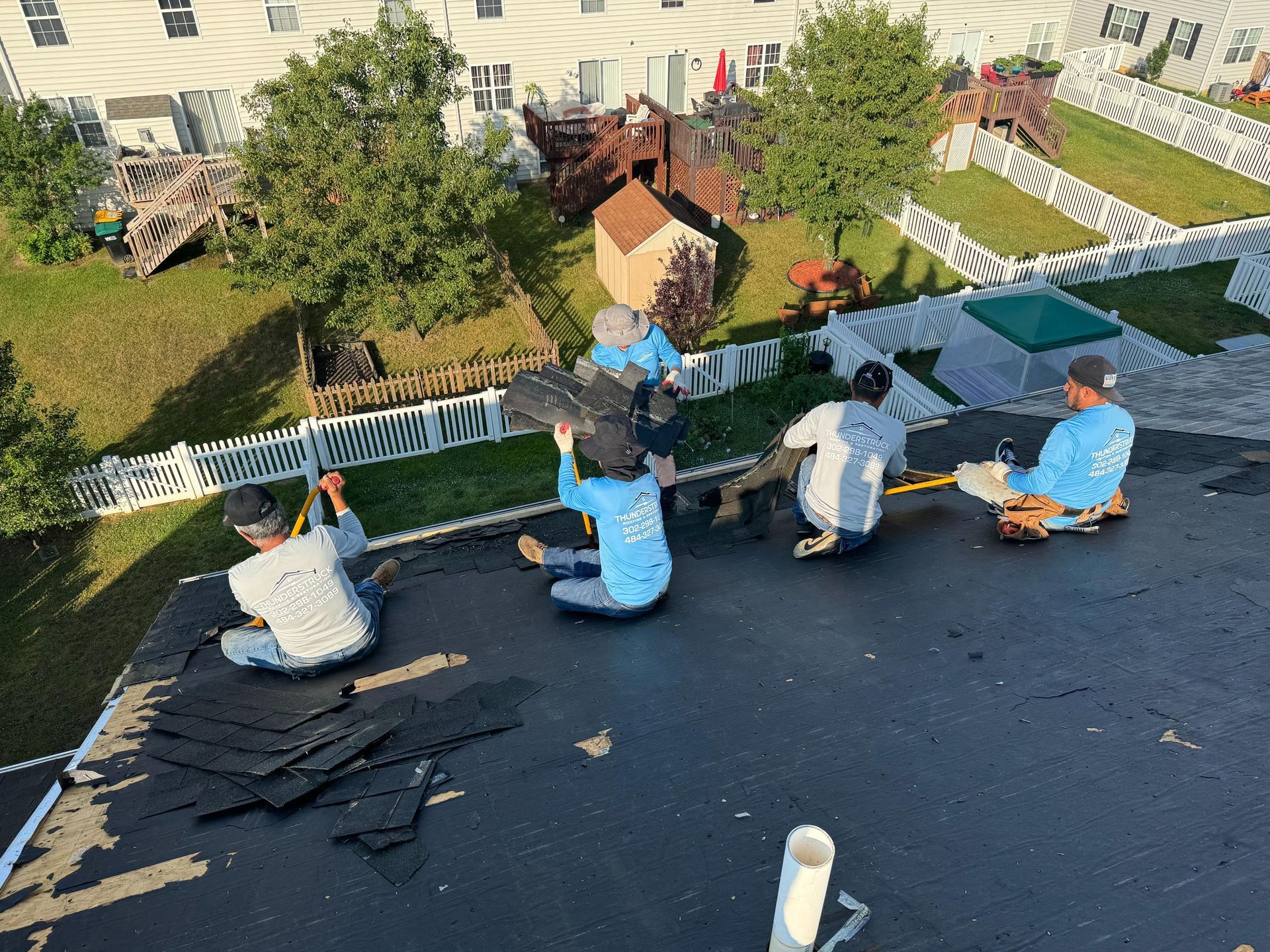 A group of people are working on a roof.