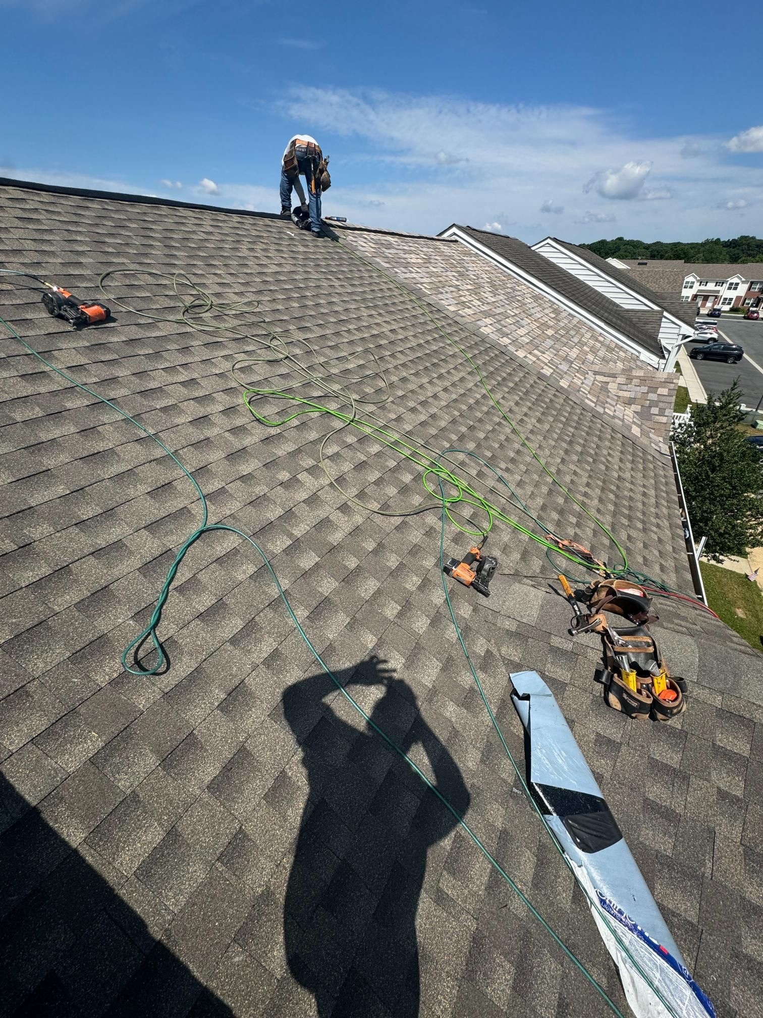 A man is standing on top of a roof.