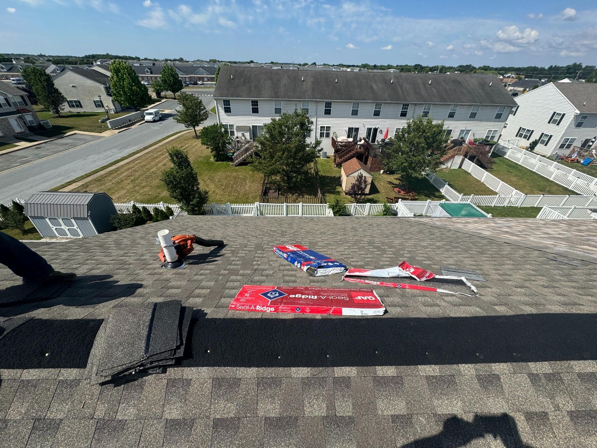 A man is working on the roof of a house.