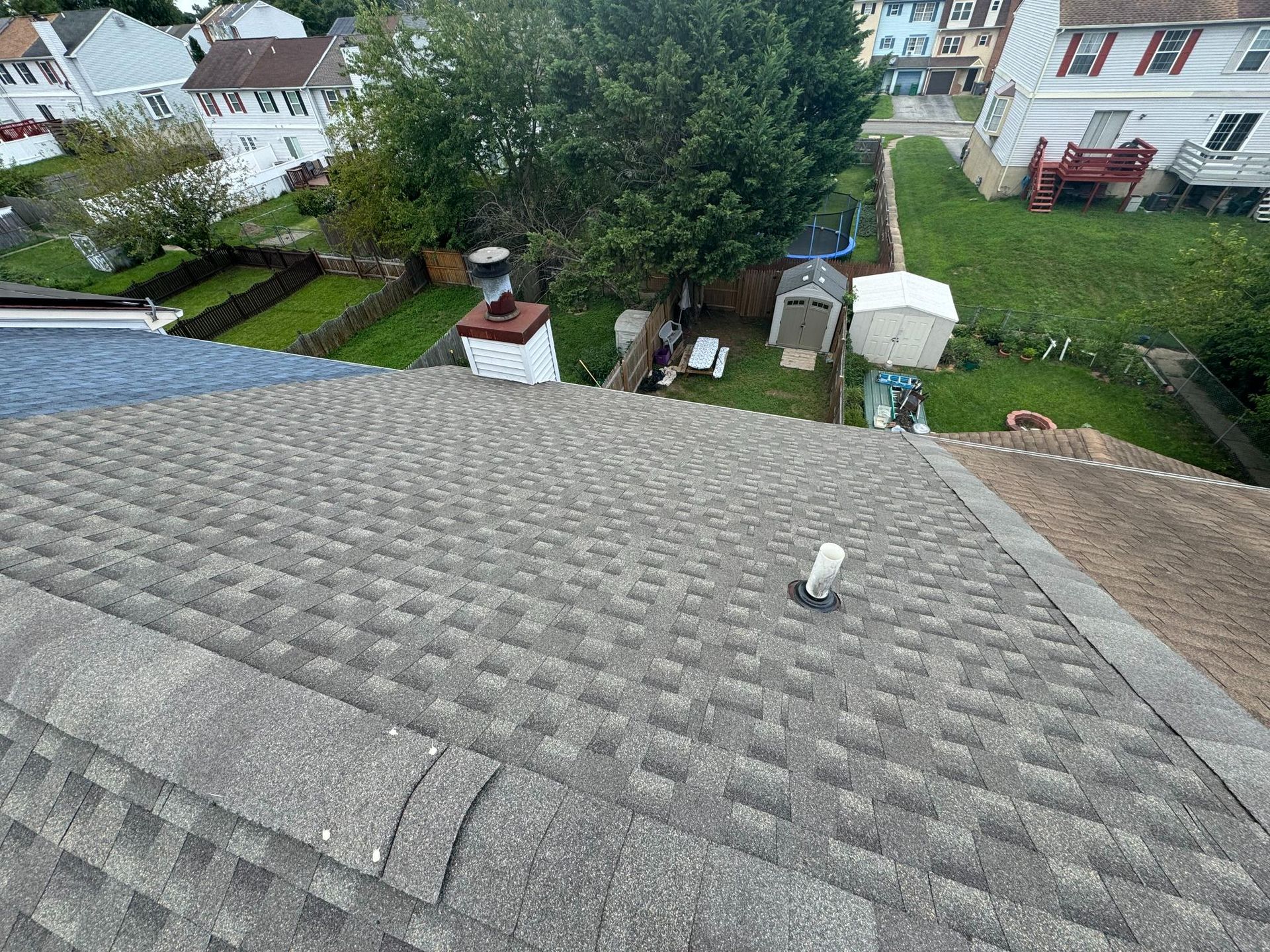 An aerial view of a roof with a chimney on it.