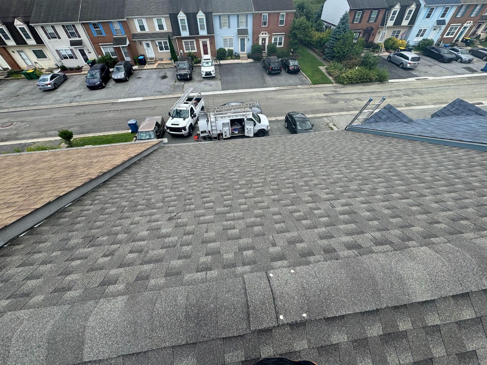 An aerial view of a roof with a lot of cars parked on it.