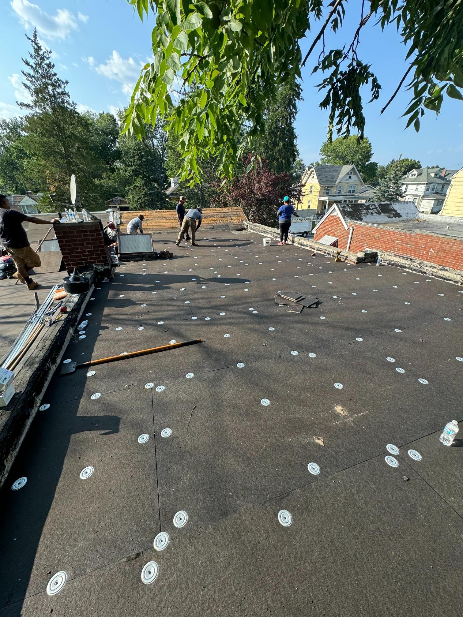A group of people are working on a roof.