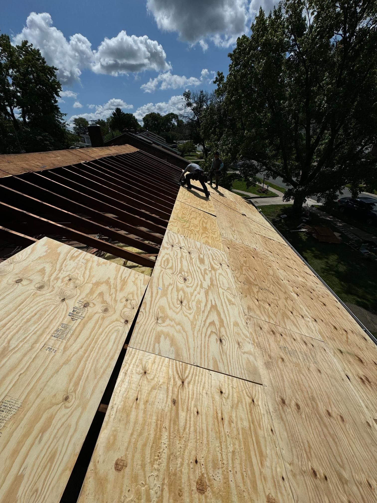 A man is working on the roof of a house.