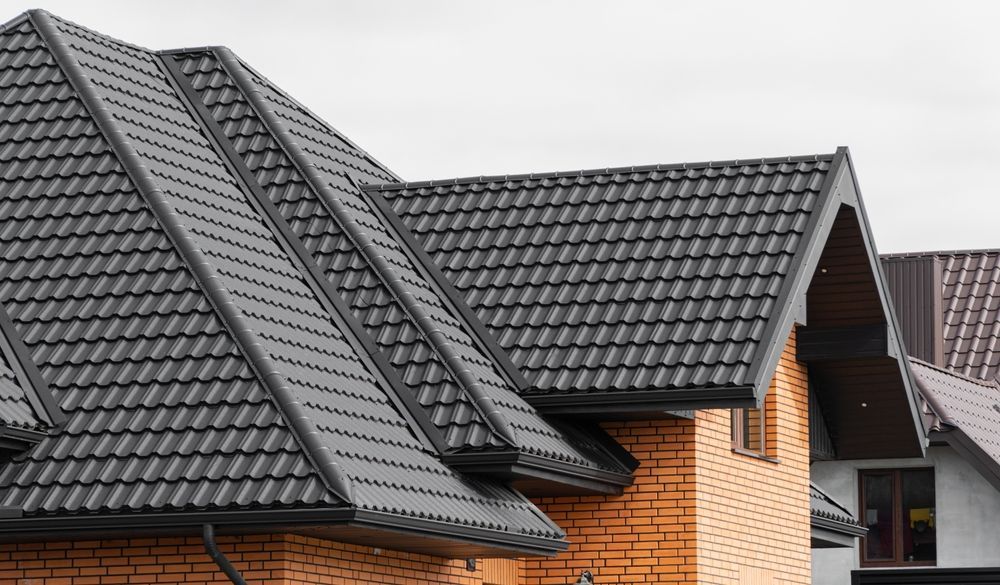 A close up of a gutter with a gutter guard on it.