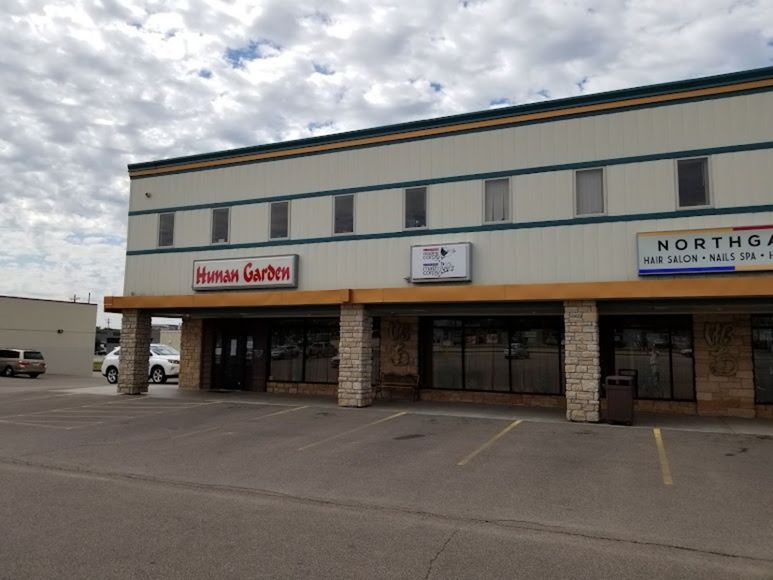 Exterior view of a commercial building with storefronts.